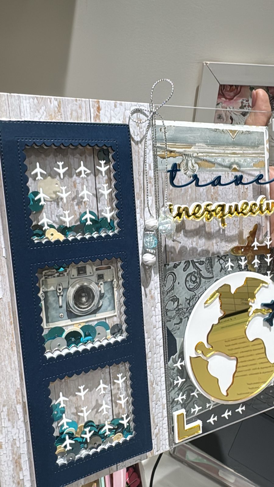 Página de scrapbook com temática de viagens, globo dourado, ícones de aviões e ilustração de câmera